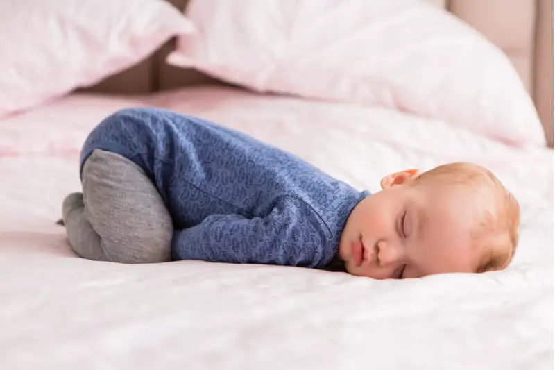 why do babies sleep with their butts in the air